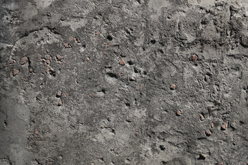 Concrete texture with red crushed stone inclusions for abstract stone background, wallpaper, pattern.