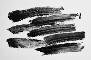 A grayscale image of rough, textured brushstrokes in black on a plain white background