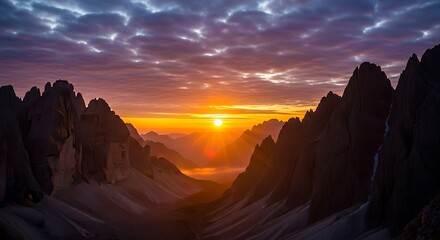 Fototapeta premium Majestic Mountain Peaks Catch the First Light of Dawn Under a Dramatic Cloudscape, Showcasing Nature's Beauty.