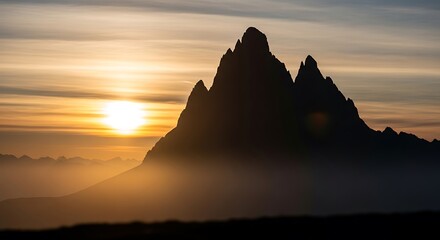 Majestic Mountain Silhouette at Dawn: Golden Sunrise Illuminates Rugged Peaks, Creating a Scenic and Dramatic Landscape.