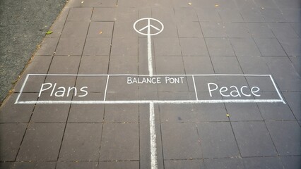 Chalk drawing of balance and peace symbol on outdoor pavement