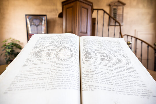 Parfondeval, Vervins, Aisne, Hauts-de-France, Grand-Est, France, August, 28th, 2025, Bible displayed in sunlit vintage chapel setting, Historical scripture showcased amid warm chapel ambiance and