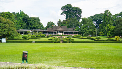 Scenic view of lush green golf course with clubhouse in background