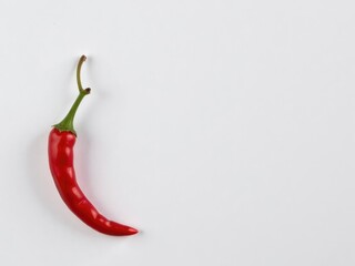Red chili pepper on white surface