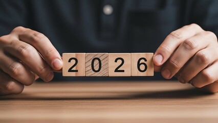 3d illustration of the year 2026 is displayed on wooden blocks held by hands, symbolizing future planning, forecasting, and anticipation of upcoming events and milestones