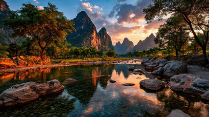 Sunset light illuminating towering mountains and calm reflective river in a serene valley landscape