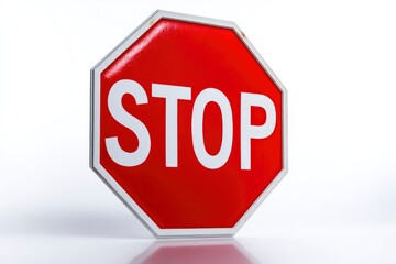 Red stop sign with a white border  letters reads STOP against a light backdrop casting a soft shadow