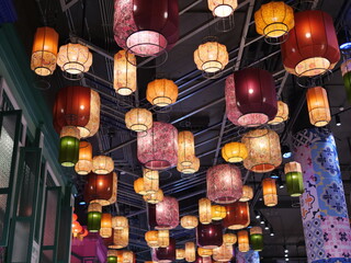 Colorful Lanterns Hanging from Ceiling in Vibrant Indoor Setting
