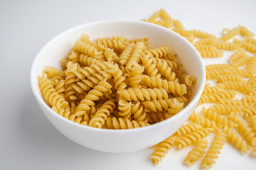 Uncooked Fusilli Pasta in a White Bowl