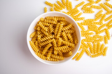 Uncooked Fusilli Pasta in a White Bowl
