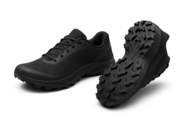 Pair of black athletic trail running shoes isolated on transparent background