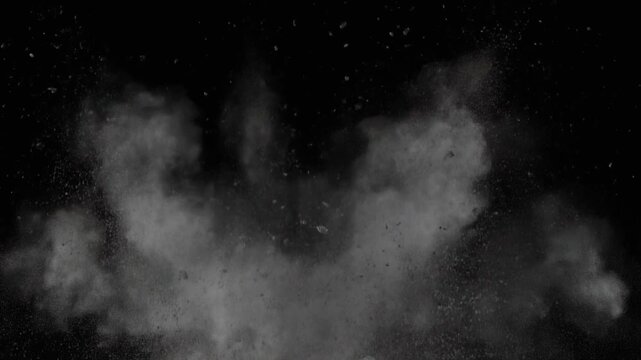 Explosive ground burst VFX element, debris and dust rising rapidly on a black background ready for compositing.