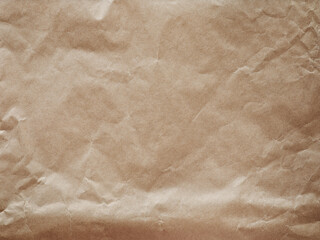 Old crumpled paper sheet or parchment texture background. Element for design. Top view.