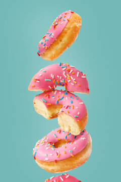 Creative concept of donuts on the turquoise background. Desserts, bakery pastries.
