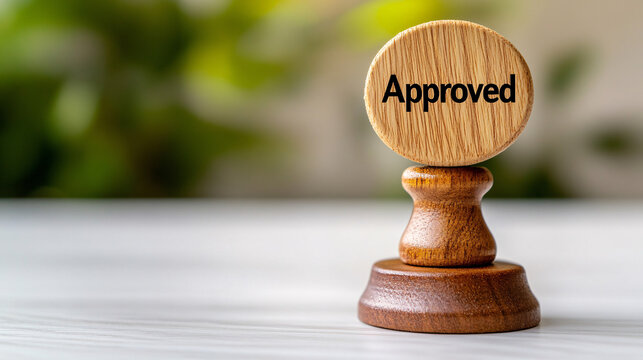 Wooden stamp with the word Approved for official business document use