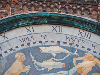 Astronomical clock showing zodiac signs Aries and Pisces on Torrazzo bell tower, Cremona, Italy