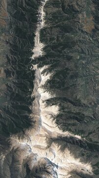 View on mountain ridge covered with snow. Camera is moving backward. Vertical video. Animation based on image by NASA
