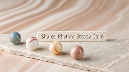 Three decorative marbles aligned in soft neutral composition