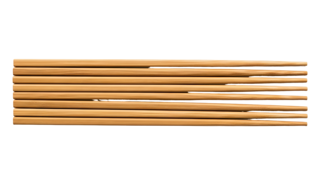 A close-up view of a collection of wooden chopsticks on a black background