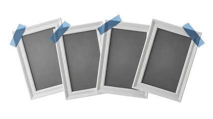 Four blank photo frames with blue tape ready for displaying memories