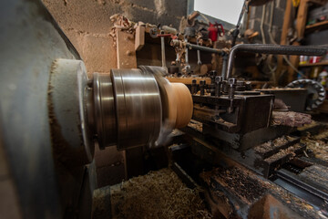 Woodworking Lathe Shaping Wood With Metal Tools In Workshop Carpentry Equipment For Wood Turning And Woodworking.