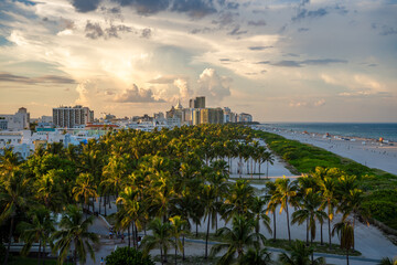 Elevated sunset view across palm trees of Lummus Park of South Beach, Miami Beach in Florida