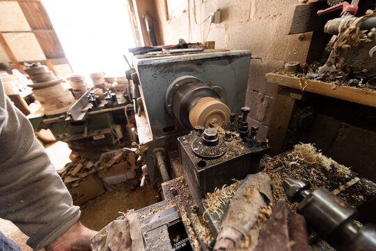 Woodworking Lathe Shaping Wood With Metal Tools In Workshop Carpentry Equipment For Wood Turning And Woodworking.
