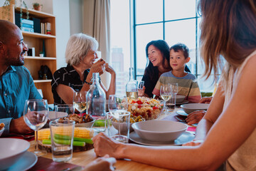 Family and friends reunion at home. Multi-generational family gathering having lunch at home