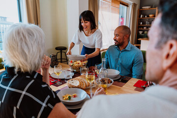 Family and friends reunion at home. Friends and family enjoying a pasta salad dinner party