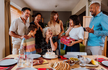 Family and friends reunion at home. Multi-generational happy family celebrating grandmother's birthday
