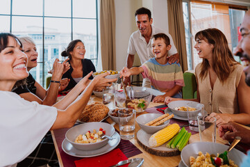 Family and friends reunion at home. Happy multigenerational family enjoying meal together at home