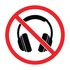 Prohibition symbol overlaying black silhouette of over ear headphones indicating no listening devices allowed