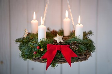 Hanging Advent Wreath with Lit Candles and Pine Decorations