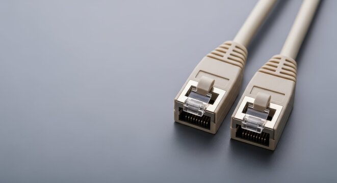 Close up of Ethernet cable connectors, Ethernet cable for computer connection on gray surface. Ethernet cable provides networking and fast internet access, reliable connection.