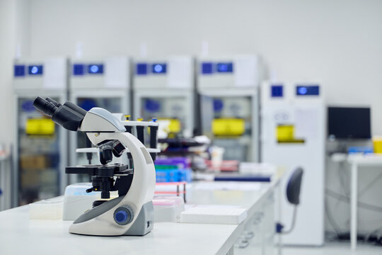 Microscope on laboratory bench in modern research facility with storage units - Powered by Adobe
