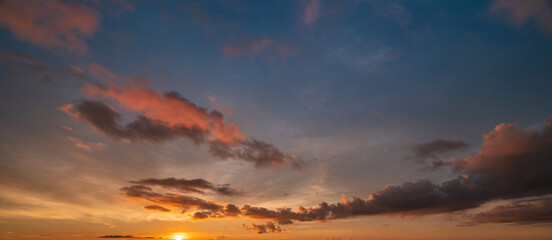 Warm sunset sky with vivid orange clouds and dramatic evening light.