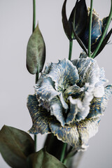Beautiful fresh blue eustoma flower on the grey background, close up macro view