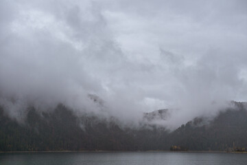 Thick valley fog wrapping mountain silhouettes