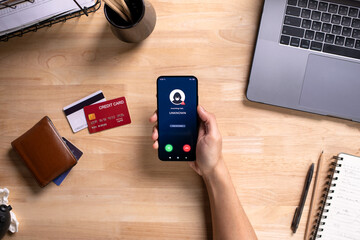 Receiving call from unknown person or Scammer, Hands holding phone with incoming call from scammer