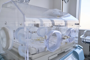 Newborn incubator in a hospital room providing warmth and care for preterm babies