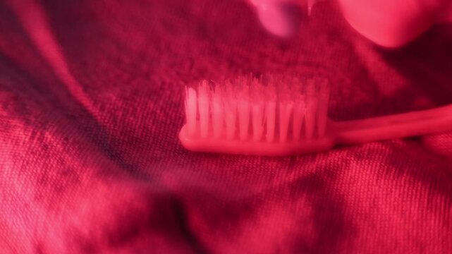 Stockholm, Sweden A person squeezes the last toothpaste out of a tube of toothpaste onto a toothbrush. 