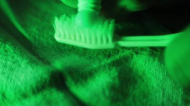 Stockholm, Sweden A person squeezes the last toothpaste out of a tube of toothpaste onto a toothbrush. 