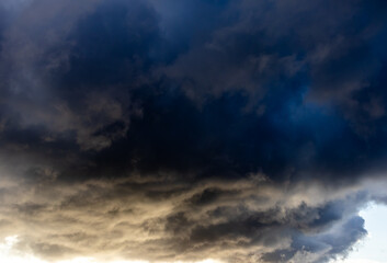 Dark storm clouds with pale light beneath