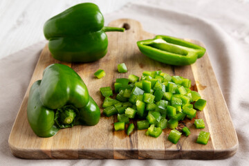 Organic Chopped Green Bell Peppers arranged on a Cutting Board, side view.