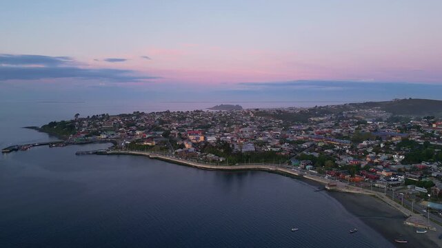 Chiloe Island, Chile: Dramatic aerial footage of sunset over Ancud residential areas, town in Chiloe Island in Lake District of Chile. Taken orbit motion