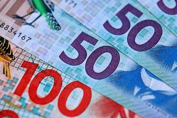 Obraz premium New Zealand dollar money bills in big amount on table close up. Rich life concept in New Zealand. Business and economy