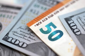 One hundred US dollar bill banknotes and fifty european Euro currency banknote. Concept of currency exchange between USD and EUR