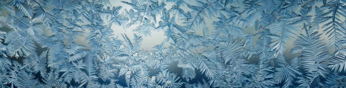 4K Ultrawide Soft focus snowy surface panoramic background - A close-up view of intricate ice crystals on a window pane. 