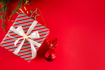 Bright red Christmas, New Year background with Christmas tree balls and decorations, holiday gift...