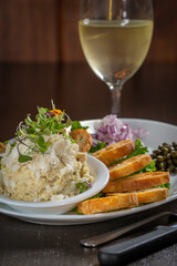 Fish dip with toast, diced onions and capers.